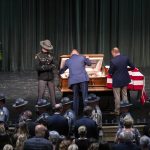 
              Officers close the casket for Floyd County Deputy William Petry at the Mountain Arts Center in Prestonsburg, Ky., Tuesday, July 5, 2022. Dep. Petry was killed when a man with a rifle opened fire on police attempting to serve a warrant Thursday, June 30. (Silas Walker/Lexington Herald-Leader via AP)
            