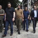 
              In this photo provided by the Ukrainian Foreign Ministry Press Office, Austrian Foreign Minister Alexander Schallenberg, right, and Czech Republic's Foreign Minister Jan Lipavsky, second left, pass by houses destroyed by the Russian shelling in Hostomel, close to Kyiv, Ukraine, Wednesday, July 20, 2022. (Ukrainian Foreign Ministry Press Office via AP)
            