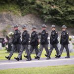 
              Kentucky state troopers walk out of the cemetery following the ceremony for Floyd County Deputy William Petry in Prestonsburg, Ky., Tuesday, July 5, 2022.  Petry and two Prestonsburg city police officers were killed while serving a warrant at a home in the county. (Silas Walker/Lexington Herald-Leader via AP)
            