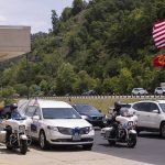 
              The hearse flanked by motorcycle police prepares to take the body of Floyd County Deputy William Petry from the Mountain Arts Center to the cemetery in Prestonsburg, Ky., Tuesday, July 5, 2022. Dep. Petry and two Prestonsburg city police officers were killed while serving a warrant at a home in the county. (Silas Walker/Lexington Herald-Leader via AP)
            