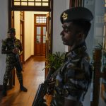 
              Army soldiers stand guard at prime minister Ranil Wickremesinghe's office building in Colombo, Sri Lanka, Thursday, July 14, 2022. Sri Lankan protesters retreated from government buildings they seized and military troops reinforced security at the Parliament on Thursday, establishing a tenuous calm in a country in both economic meltdown and political limbo.(AP Photo/Rafiq Maqbool)
            