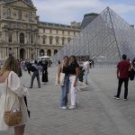
              Tourists take pictures in front of the Pyramide in the Louvre Museum courtyard, in Paris, France, Monday, June 20, 2022. Tourism is on the rebound around the world this summer after two years of pandemic restrictions, with museums and flights packed – but the global recovery is hampered by inflation and rising virus infection rates in many regions. (AP Photo/Francois Mori)
            