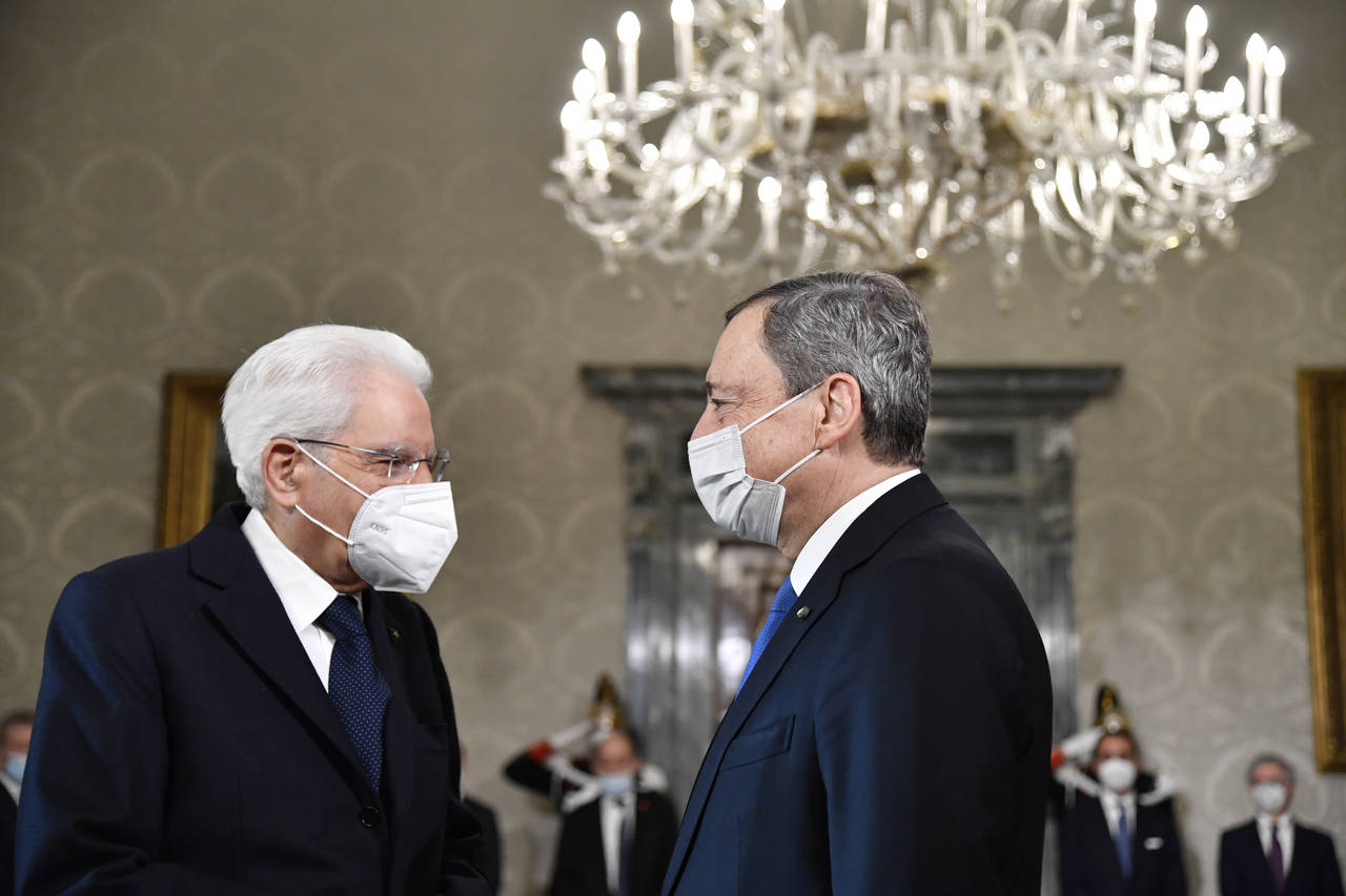 FILE - Italy's President Sergio Mattarella, left, greets Italy's Prime Minister Mario Draghi at the...