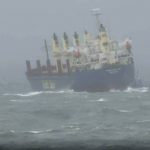 
              In this image taken from video shows a stranded cargo ship off Wollongong, Australia, Monday, July 4, 2022. A cargo ship that left the Australian port of Wollongong on Monday morning has lost power and is drifting at sea south of Sydney with 21 crew on board. According to local media, the ship is now anchored near the coast and a tugboat is on location to try and prevent it from getting closer to nearby cliffs and rocks. (Australian Broadcasting Corporation via AP)
            