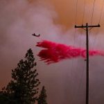 A plane drops retardant while battling the Oak Fire in Mariposa County, Calif., on Friday, July 22, 2022. (AP Photo/Noah Berger)