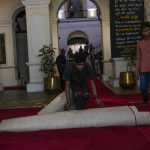 
              Protesters roll a carpet at the official residence of President Gotabaya Rajapaksa in in Colombo, Sri Lanka, Thursday, July 14, 2022. With the country sinking into political chaos, Rajapaksa and his wife fled to the Maldives on Wednesday aboard an air force jet. He made the prime minister acting president in his absence — a move that further roiled passions among a public that blames Rajapaksa for an economic crisis that has caused severe shortages of food and fuel. (AP Photo/Rafiq Maqbool)
            