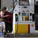 
              A woman checks her credit cards at a gas station in Palatine, Ill., Thursday, June 30, 2022.in Palatine, Ill., Thursday, June 30, 2022. U.S consumers have so far defied higher prices for gas, food, and rent and have been spending more in 2022, providing crucial support to the economy. (AP Photo/Nam Y. Huh)
            