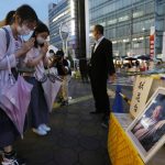 
              A photo of former Prime Minister Shinzo Abe is displayed on a makeshift memorial near the scene where Abe was fatally shot while delivering his speech to support a Liberal Democratic Party's candidate on Friday, in Nara, Saturday, July 9, 2022.  (Yosuke Mizuno/Kyodo News via AP)
            