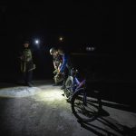 
              Ukrainian policemen stop a man on his bicycle to check his documents and belongings, during their night time curfew patrol, in Donetsk region, eastern Ukraine, Friday, July 22, 2022. (AP Photo/Nariman El-Mofty)
            