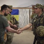 
              In this photo provided by the Ukrainian Presidential Press Office on Friday, July 8, 2022, Ukrainian President Volodymyr Zelenskyy, left, awards a serviceman as he visits the war-hit Dnipropetrovsk region. (Ukrainian Presidential Press Office via AP)
            