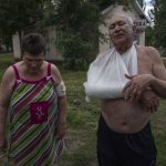 
              Mykola Zavodovskyi, right, and Tetiana Zavodovska, injured from a rocket attack that hit a five-story building, receive treatment at a hospital, in Kramatorsk, eastern Ukraine, Tuesday, July 19, 2022. (AP Photo/Nariman El-Mofty)
            