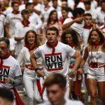 
              Runners gather before the last "encierro" or running of the bulls during the San Fermin festival in Pamplona, northern Spain, Thursday, July 14, 2022. (AP Photo/Alvaro Barrientos)
            