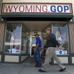 
              Two men walk in front of the Wyoming Republican Party headquarters in Cheyenne, Wyo., on Tuesday, July 19, 2022. Rep. Liz Cheney, Wyoming's congresswoman since 2016. is facing a Donald Trump-backed opponent, attorney Harriet Hageman, in the state's upcoming Republican primary. (AP Photo/Thomas Peipert)
            