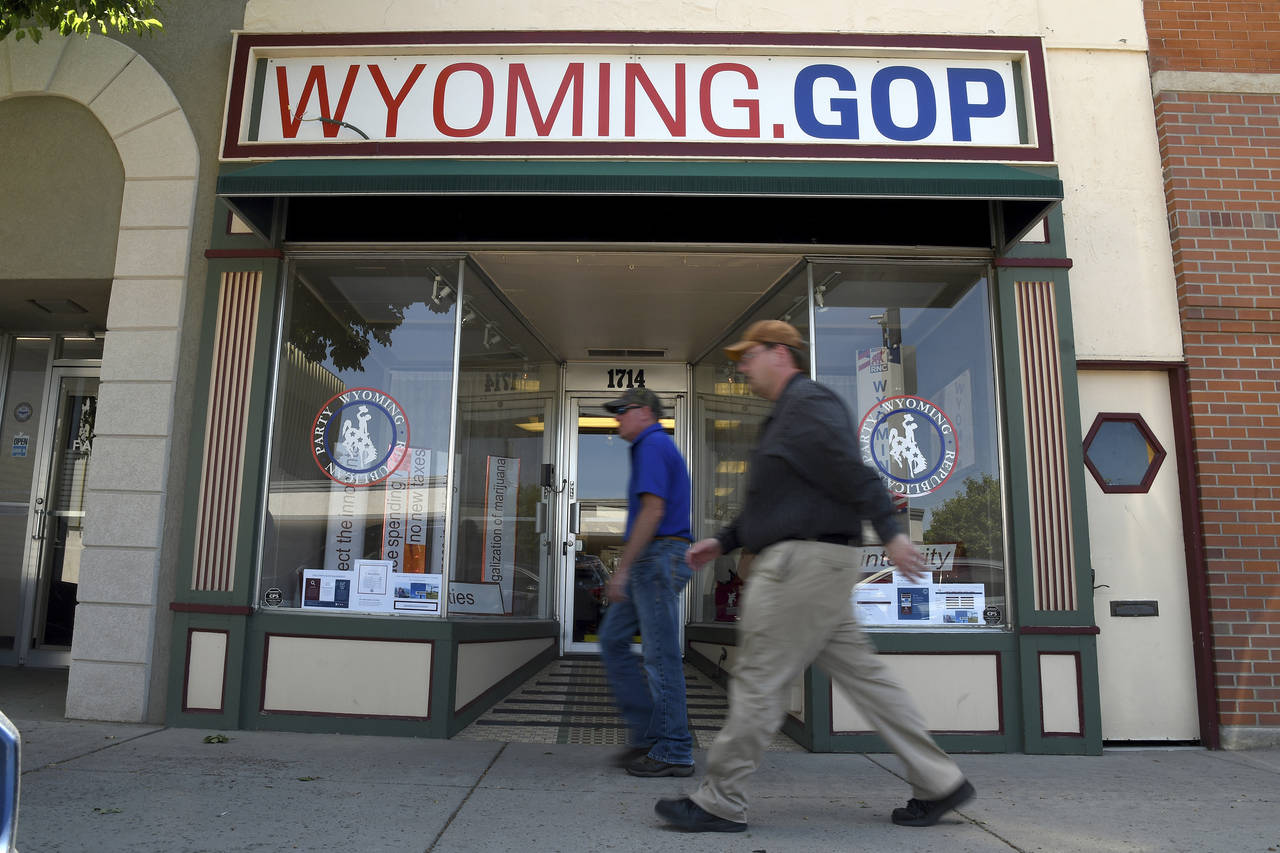 Two men walk in front of the Wyoming Republican Party headquarters in Cheyenne, Wyo., on Tuesday, J...