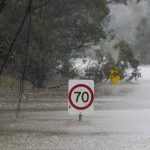 
              Traffic signs sit submerged along a flooded road in Londonderry on the outskirts of Sydney, Australia, Monday, July 4, 2022. More than 30,000 residents of Sydney and its surrounds have been told to evacuate or prepare to abandon their homes on Monday as Australia's largest city braces for what could be its worst flooding in 18 months. (AP Photo/Mark Baker)
            