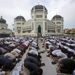 
              Indonesians perform a prayer marking the Eid al-Adha holiday at Al Mashun Great Mosque in Medan, Indonesia, Sunday, July 10, 2022. Muslims around the world are celebrating Eid al-Adha, the Festival of Sacrifice, by slaughtering sheep, goats, cows and camels and sharing the meat with the poor to commemorate the Quranic story of the Prophet Ibrahim's willingness to sacrifice his son Ismail as an act of obedience to God. (AP Photo/Binsar Bakkara)
            