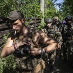 
              Ukrainian servicemen changing their position at the frontline near Kharkiv, Ukraine, on Saturday, July 2, 2022.(AP Photo/Evgeniy Maloletka)
            