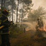 
              Firefighters puts water on a trees at a forest fire near Louchats, 35 kms (22 miles) from Landiras in Gironde, southwestern France, Monday, July 18, 2022. France scrambled more water-bombing planes and hundreds more firefighters to combat spreading wildfires that were being fed Monday by hot swirling winds from a searing heat wave broiling much of Europe. With winds changing direction, authorities in southwestern France announced plans to evacuate more towns and move out 3,500 people at risk of finding themselves in the path of the raging flames. (Phillippe Lopez)
            