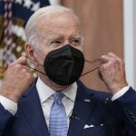 
              FILE - President Joe Biden removes his face mask as he arrives to speak about the economy during a meeting with CEOs in the South Court Auditorium on the White House complex in Washington, Thursday, July 28, 2022. Biden tested positive for COVID-19 again Saturday, July 30, slightly more than three days after he was cleared to exit coronavirus isolation, the White House said, in a rare case of “rebound” following treatment with an anti-viral drug. (AP Photo/Susan Walsh, File)
            