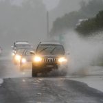 
              Cars drive through flood waters in Richmond on the outskirts of Sydney, Australia, Monday, July 4, 2022. More than 30,000 residents of Sydney and its surrounds have been told to evacuate or prepare to abandon their homes on Monday as Australia's largest city braces for what could be its worst flooding in 18 months.(AP Photo/Mark Baker)
            