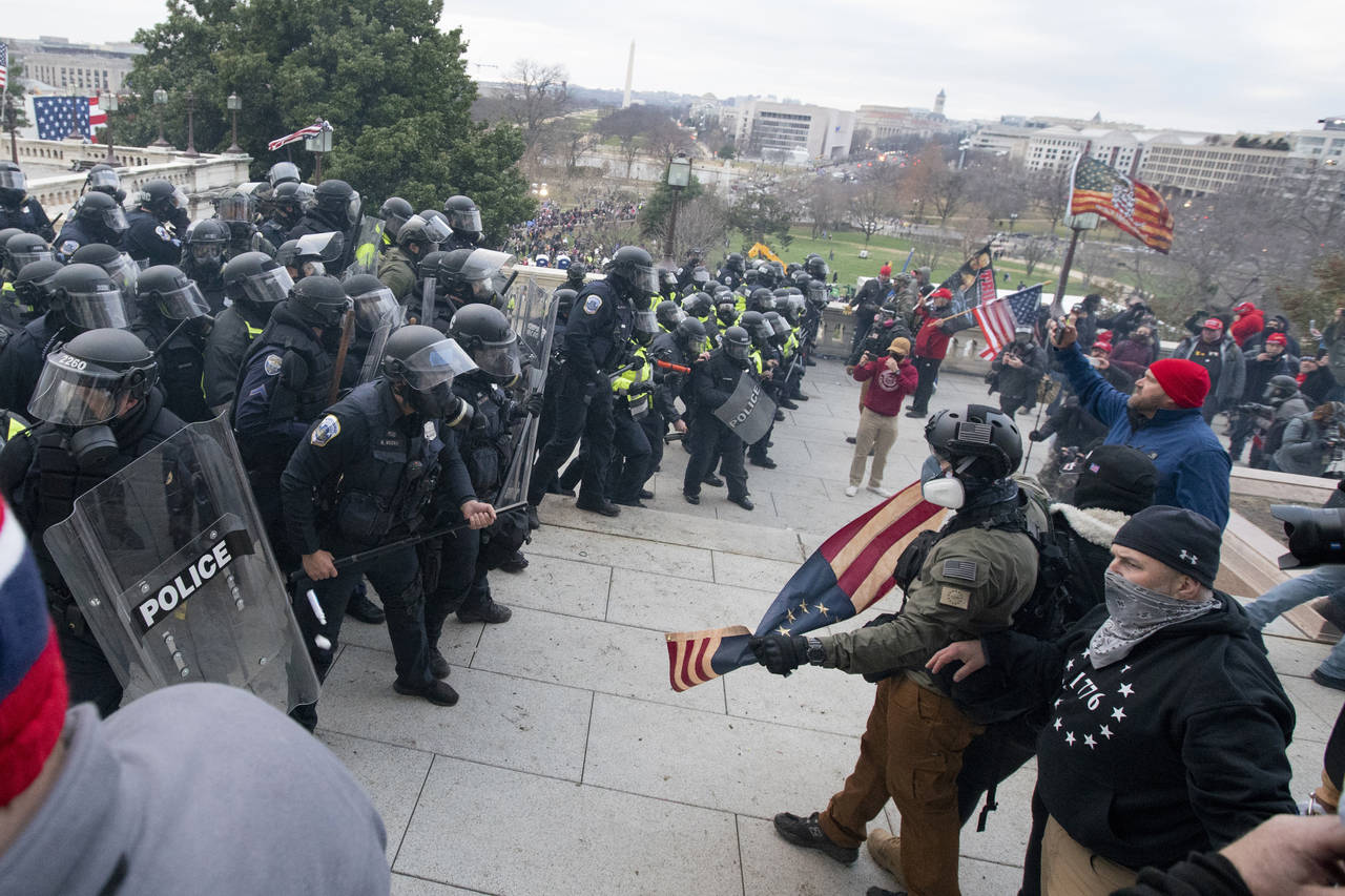 FILE - Rioters face off with police at the U.S. Capitol on Jan. 6, 2021, in Washington. A growing n...