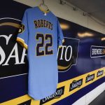 
              A jersey honoring 8-year-old Cooper Roberts, who was paralyzed from the waist down during a July 4 mass shooting in Highland Park, is seen in the Milwaukee Brewers dugout before a baseball game against the Pittsburgh Pirates Friday, July 8, 2022, in Milwaukee. (AP Photo/Morry Gash)
            