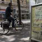 
              A cyclist rides past an exchange office in downtown Zagreb, Croatia, Tuesday, July 12, 2022. The European Union is set to remove the final obstacles for Croatia to adopt the euro, ensuring the first expansion of the currency bloc in almost a decade. (AP Photo/Darko Bandic)
            