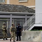 
              Law enforcement search in downtown Highland Park, a Chicago suburb, after a mass shooting at the Highland Park Fourth of July parade, Monday, July 4, 2022. (AP Photo/Nam Y. Huh)
            