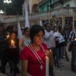 
              Residents hold a candlelight vigil to pray for three local teenagers in hopes they are not among the 53 migrants who died in a stifling, abandoned trailer in Texas, in San Marcos Atexquilapan, Veracruz state, Mexico, late Thursday, June 30, 2022. One of the three teens, Misael, was later confirmed to have perished in the trailer while the fate of Jair and Yovani remained unknown. (AP Photo/Felix Marquez)
            