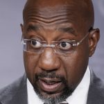 FILE - Sen. Raphael Warnock, D-Ga., joins Senate Majority Leader Chuck Schumer, D-N.Y., to speak to reporters after the Senate advanced a $280 billion bill designed to boost the U.S. semiconductor industry and to accelerate high tech research that backers say will be critical to the economy in future decades, at the Capitol in Washington, July 26, 2022. Warnock is running for his first full Senate term, pitching himself as a lawmaker willing to do whatever it takes to help his state. (AP Photo/J. Scott Applewhite, File)