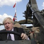 
              FILE - Britain's Foreign Secretary Boris Johnson talks to a British armed forces serviceman based in Orzysz, in northeastern Poland, during a ceremony at the Tomb of the Unknown Soldier and following talks on security with his Polish counterpart Jacek Czaputowicz in Warsaw, Poland, Thursday, June 21, 2018. British media say Prime Minister Boris Johnson has agreed to resign on Thursday, July 7 2022, ending an unprecedented political crisis over his future. (AP Photo/Czarek Sokolowski, File)
            