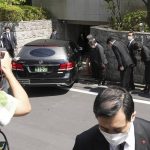 
              A hearse which is believed to carry the body of former Prime Minister Shinzo Abe, arrives at his home Saturday, July 9, 2022, in Tokyo. (AP Photo/Eugene Hoshiko)
            