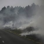 
              Smoke rises from at a forest fire near Louchats, 35 kms (22 miles) from Landiras in Gironde, southwestern France, Monday, July 18, 2022. France scrambled more water-bombing planes and hundreds more firefighters to combat spreading wildfires that were being fed Monday by hot swirling winds from a searing heat wave broiling much of Europe. With winds changing direction, authorities in southwestern France announced plans to evacuate more towns and move out 3,500 people at risk of finding themselves in the path of the raging flames. (Philippe Lopez/Pool Photo via AP)
            