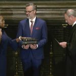 
              In this image from video provided by the Supreme Court, Chief Justice of the United States John Roberts administers the Constitutional Oath to Ketanji Brown Jackson as her husband Patrick Jackson holds the Bible at the Supreme Court in Washington, Thursday, June 30, 2022. (Supreme Court via AP)
            