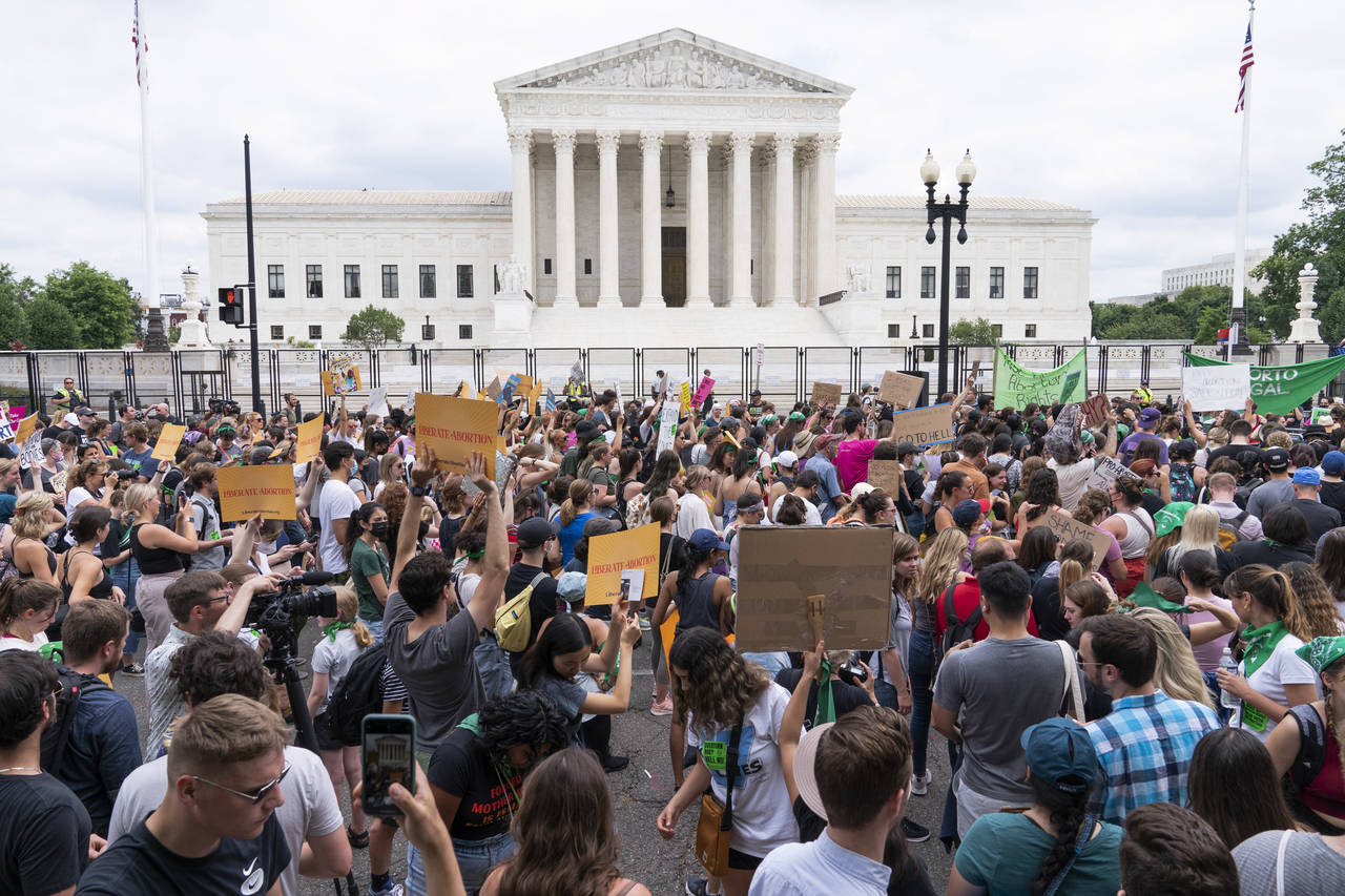 FILE - Protesters gather outside the Supreme Court in Washington, Friday, June 24, 2022. After the ...