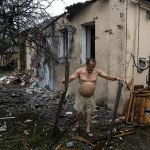 
              A local man clears rubble from his house which was destroyed after a Russian attack in a residential neighborhood in downtown Kharkiv, Ukraine, on Monday, July 11, 2022. The top official in the Kharkiv region said Monday the Russian forces launched three missile strikes on the city targeting a school, a residential building and warehouse facilities. (AP Photo/Evgeniy Maloletka)
            