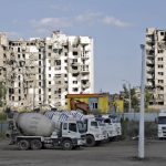 
              Cement trucks parked at a construction site of an apartment building under construction for residents of Mariupol affected by hostilities, in Mariupol, in territory under the government of the Donetsk People's Republic, eastern Ukraine, Friday, July 1, 2022. (AP Photo)
            
