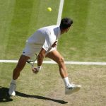 
              Serbia's Novak Djokovic returns to Britain's Cameron Norrie in a men's singles semifinal on day twelve of the Wimbledon tennis championships in London, Friday, July 8, 2022. (AP Photo/Kirsty Wigglesworth)
            