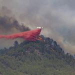
              A firefighting plane drops retardant on a forest fire in the Castellgali area of Catalonia, Spain on Sunday July 17, 2022. Firefighters battled wildfires raging out of control in Spain and France as Europe wilted under an unusually extreme heat wave that authorities in Madrid blamed for hundreds of deaths. (Lorena Sopena/Europa Press via AP)
            