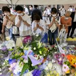 
              People offer prayers at a makeshift memorial near the scene where the former Prime Minister Shinzo Abe was fatally shot while delivering his speech to support the Liberal Democratic Party's candidate during a Friday's election campaign in Nara, Saturday, July 9, 2022.  (Kyodo News via AP)
            
