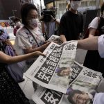 
              An employee distributes extra editions of the Yomiuri Shimbun newspaper reporting on Japan's former Prime Minister Shinzo Abe was shot, Friday, July 8, 2022, in Tokyo. Former Japanese Prime Minister Shinzo Abe, a divisive arch-conservative and one of his nation's most powerful and influential figures, has died after being shot during a campaign speech Friday in western Japan, hospital officials said. (AP Photo/Eugene Hoshiko)
            