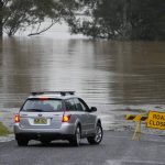 
              A car turns at a closed road in Richmond on the outskirts of Sydney, Australia, Monday, July 4, 2022. More than 30,000 residents of Sydney and its surrounds have been told to evacuate or prepare to abandon their homes on Monday as Australia's largest city braces for what could be its worst flooding in 18 months. (AP Photo/Mark Baker)
            