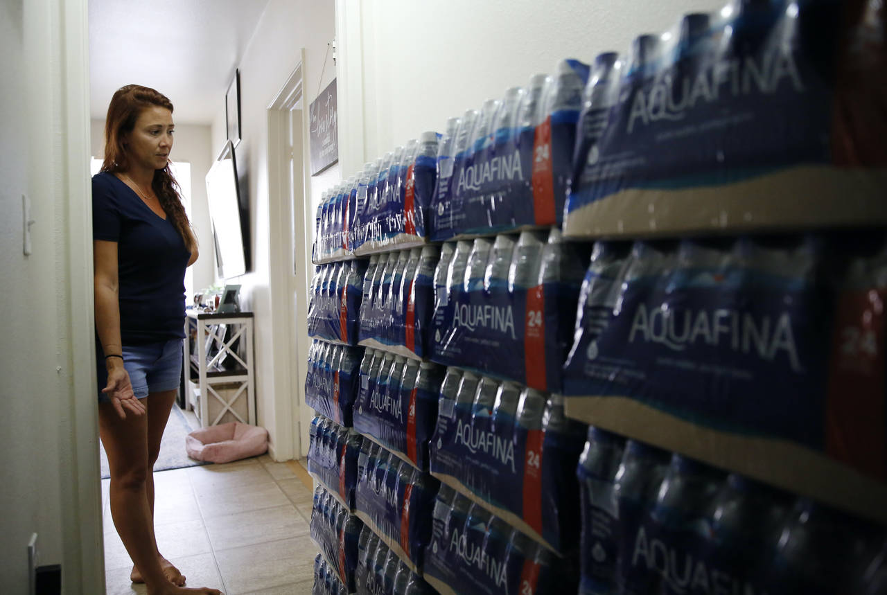 Lauren Wright, a Navy spouse whose family was sickened by jet fuel in their tap water, shows her su...