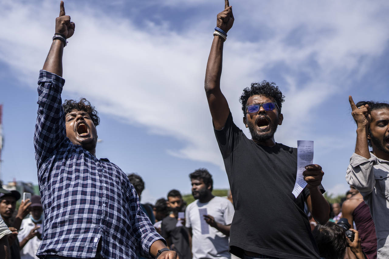 Protesters shout slogans demanding acting president and prime minister Ranil Wickremesinghe resign ...