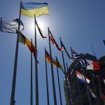 
              The Ukrainian flag, top, flies with others European flags outside the European Parliament , Tuesday, July 5, 2022 in Strasbourg, eastern France. (AP Photo/Jean-Francois Badias)
            