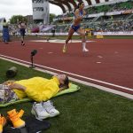 
              Yaroslava Mahuchikh, of Ukraine, lies on the field at the World Athletics Championships on Saturday, July 16, 2022, in Eugene, Ore. (AP Photo/David J. Phillip)
            