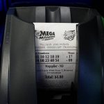 
              A Mega Millions lottery ticket is printed out of a lottery machine at a convenience store Thursday, July 21, 2022, in Northbrook, Ill. Lottery officials have raised the Mega Millions grand prize to $660 million Thursday, giving players a shot at the nation's ninth largest jackpot. (AP Photo/Nam Y. Huh)
            