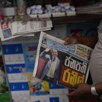
              A man holds a newspaper with news of Ranil Wickremesinghe's election in Colombo, Sri Lanka, Thursday, July 21, 2022. Sri Lanka's prime minister was elected president Wednesday by lawmakers who opted for a seasoned, veteran leader to lead the country out of economic collapse, despite widespread public opposition. (AP Photo/Rafiq Maqbool)
            