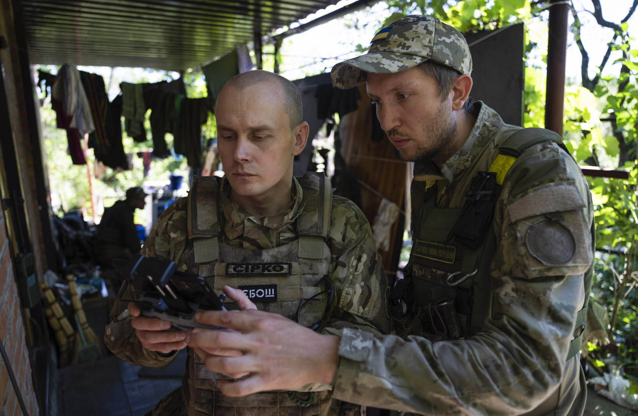 FILE - Ukrainian servicemen correcting artillery fire by drone at the frontline near Kharkiv, Ukrai...