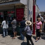 
              People wait in line outside Blue Bird Liquor to purchase Mega Millions lottery tickets in Hawthorne, Calif., Tuesday, July 26, 2022. (AP Photo/Jae C. Hong)
            